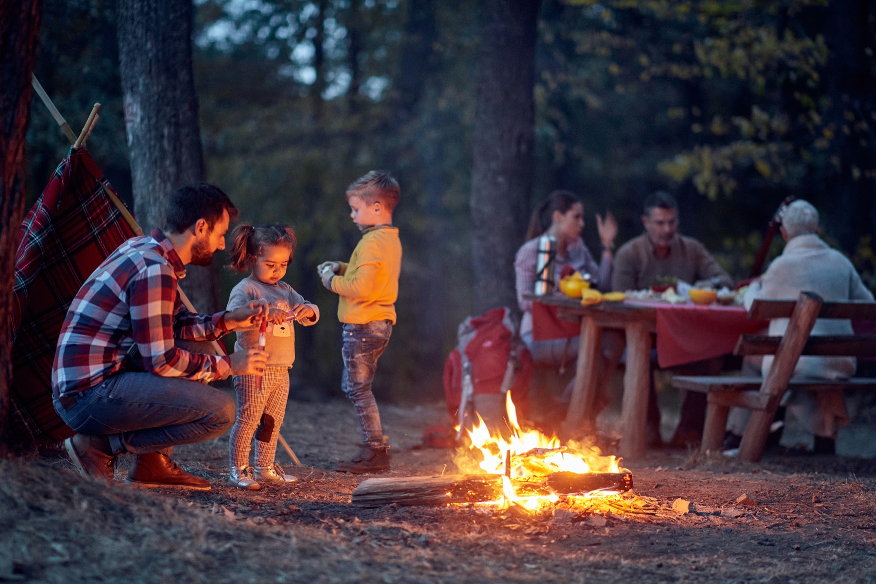 A family gathered around a campfire in the North Georgia woods